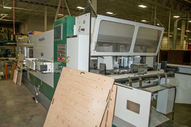 Platen die cutter in warehouse facility